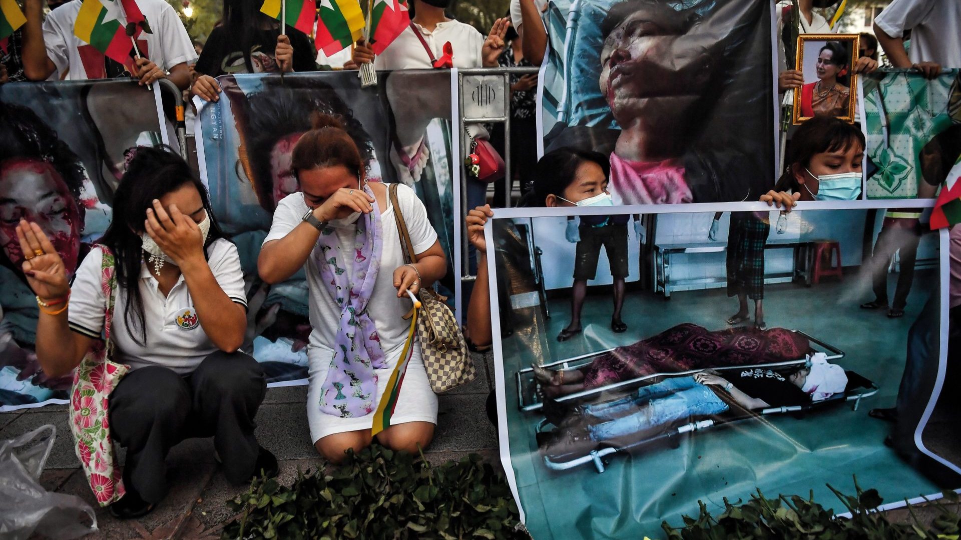 Migrants from Myanmar now living in Thailand cry during a 2021 memorial honouring protestors who died during the military coup. Photo: Lillian Suwanrumpha/AFP