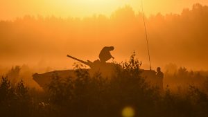 Soldiers stand on a 
tank during a training 
demonstration with the Nato 
multinational battle group eFPon at the Orzysz training 
ground in Poland this month. Photo: Omar Marques/ Getty Images