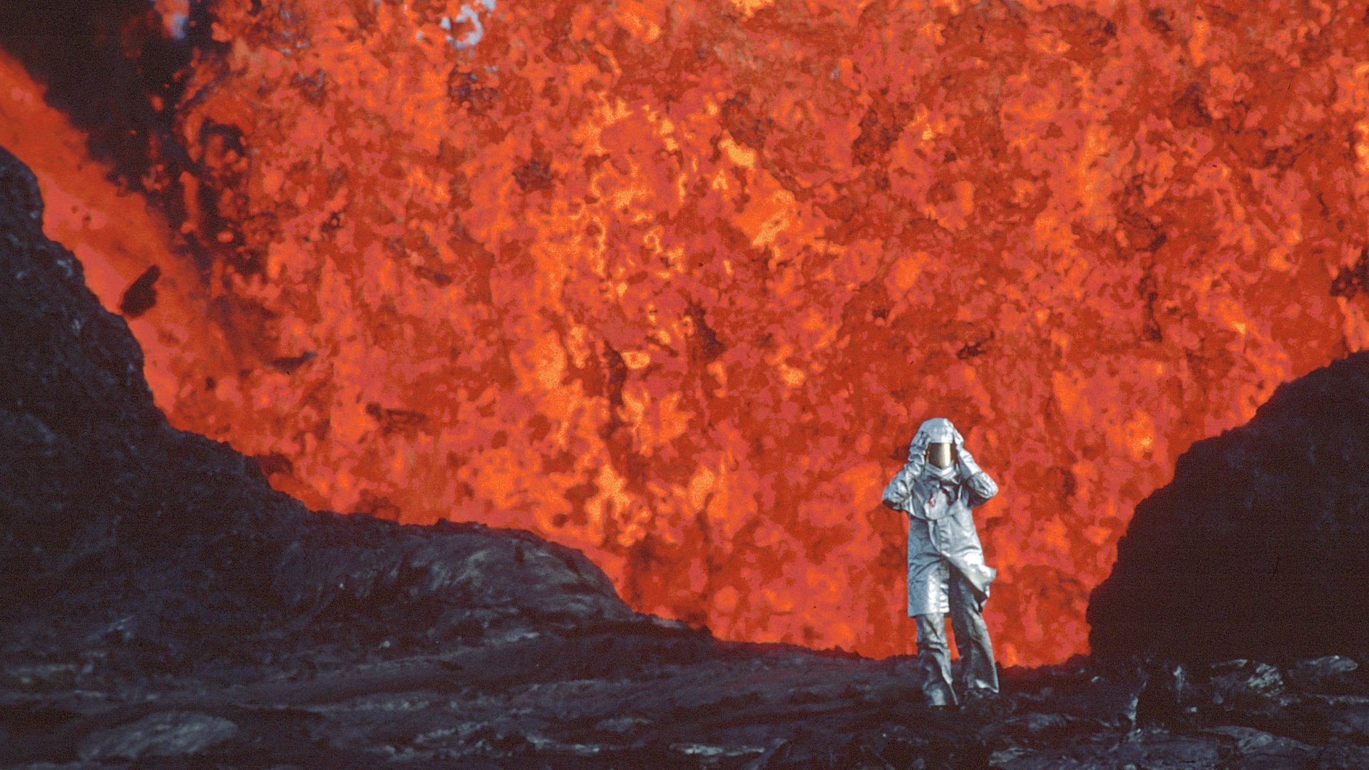 Katia Krafft wearing aluminized suit standing near lava burst at Krafla Volcano, Iceland. Photo: Image'Est
