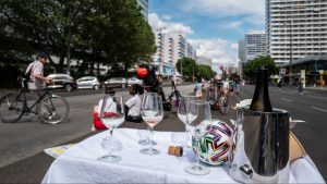 A table is set in the middle of a deserted Leipziger Strasse, one of Berlin's busiest avenues, during a protest last year (Photo by JOHN MACDOUGALL/AFP via Getty Images)