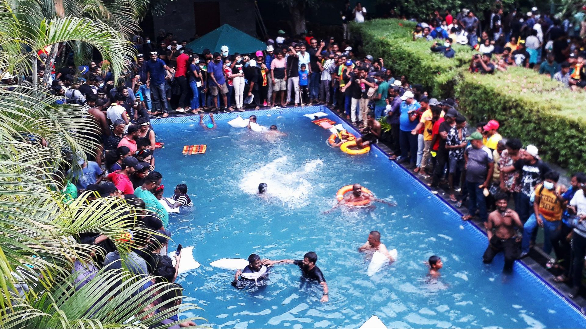 Protesters demanding the resignation of Sri Lanka’s president swim in a pool 
inside the presidential 
palace in Colombo. Photo: AFP/Getty