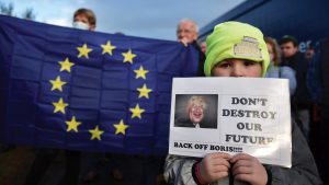 A young boy holds a Back Off Boris placard as Border Communities against Brexit protesters demonstrate in Newry, Northern Ireland. Photo: Charles McQuillan/Getty