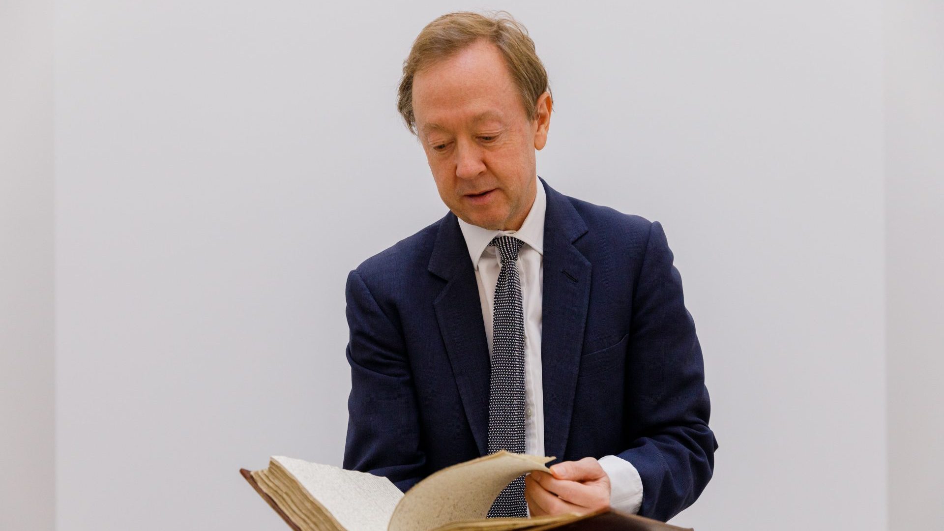 Geordie Greig examines manuscripts by Robert Burns, Jane Austen, the Bronte sisters and Sir Walter Scott. Photo: Tristan Fewings/Getty Images for Friends of the National Libraries)