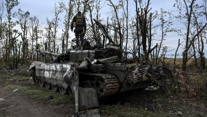 A Ukrainian soldier stands on a Russian tank near Kharkiv on 
September 11. Photo: JUAN BARRETO/AFP via Getty Images 