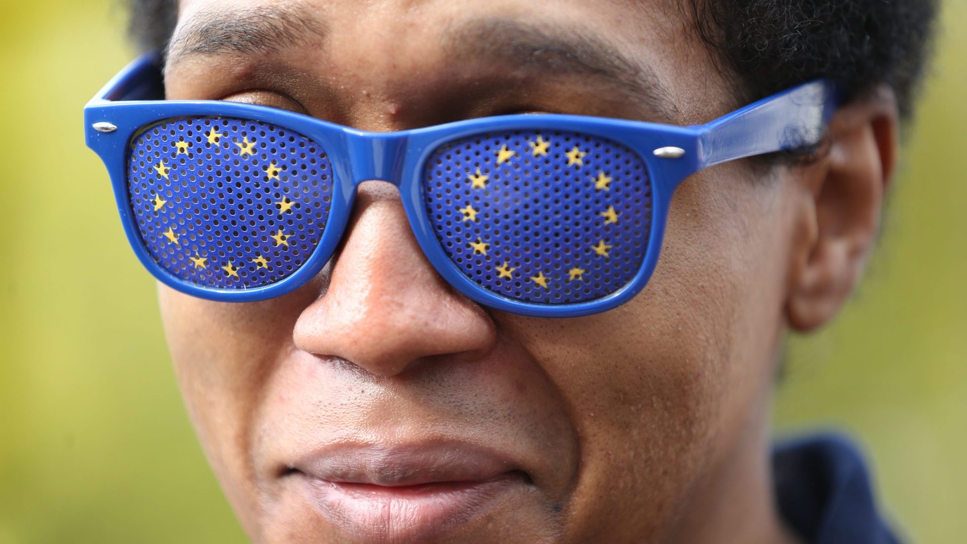 An EU supporter wears EU flag painted spectacles as he joins the march in Park Lane (Photo by Martin Pope/Getty Images)