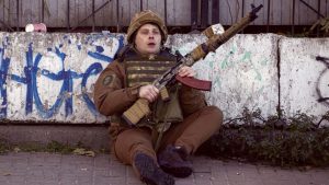 A Ukrainian soldier takes cover behind a wall during Russian attacks on Kyiv on October 17. Photo: Metin Aktas/Anadolu Agency via Getty