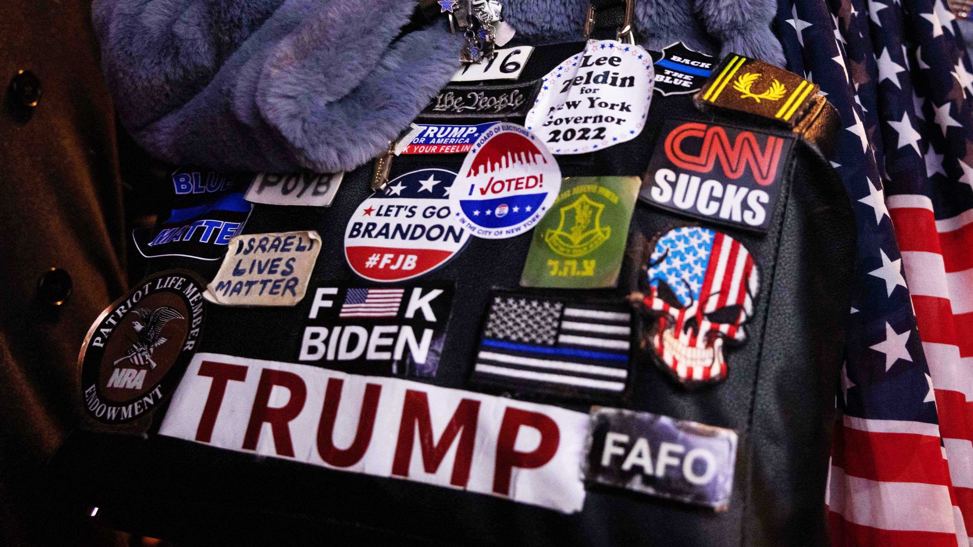 A woman holds a bag covered with pro-Trump stickers as 
supporters watch live results at an election party in New York City, November 8 2022. Photo: Yuki Iwamura/AFP/Getty