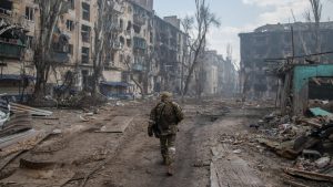 A Russian soldier walks through the rubble in Mariupol left by fierce fighting between Russian and Ukrainian forces in April. Photo: Maximilian Clarke/SOPA/LightRocket/Getty