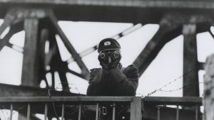 A communist border 
guard mans the Berlin Wall to prevent people trying to escape from 
East Berlin, 1964. Photo: HUM Images/Universal;