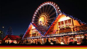 Visitors walk through the Christmas market at Alexanderplatz square under an illuminated ferris wheel. Photo: Sean Gallup Getty Images