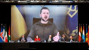 Volodymyr Zelensky appears on a giant 
screen to deliver a speech during Nato’s 
parliamentary assembly annual session in Madrid, November 2022. Photo: Oscar del Pozo/AFP/Getty