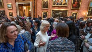 Queen Consort Camilla speaks to guests near Ngozi Fulani at the fateful 
Buckingham Palace 
meeting in November. Photo: Kin Cheung/AFP