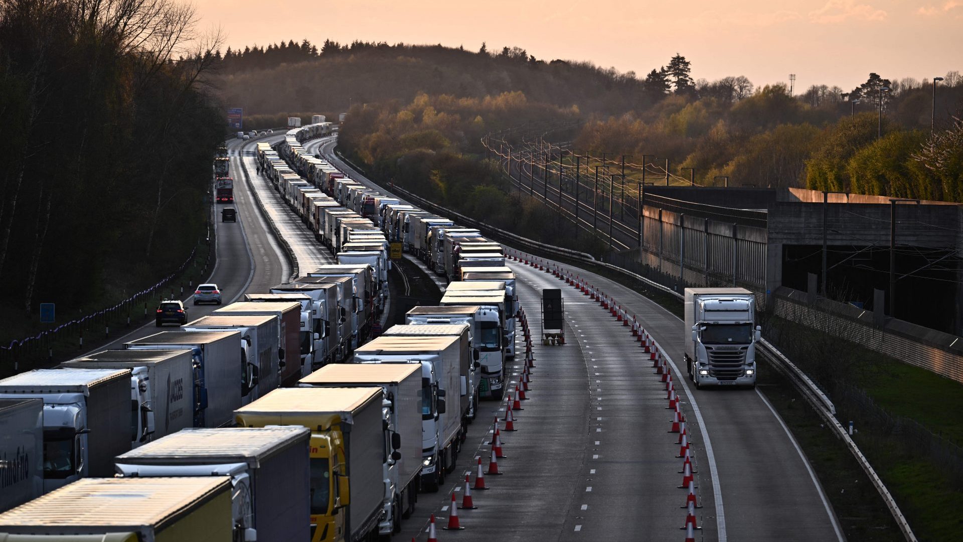 Freight lorries and HGVs queue on the M20 road near Lenham heading towards the port of Dover (Photo by BEN STANSALL/AFP via Getty Images)