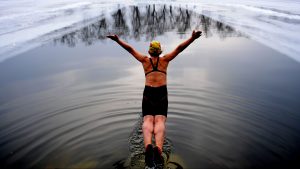 A woman jumps into a 
pool dug in the frozen river at Beiling Park in December 2016 in Shenyang, China. Photo: Visual China Group