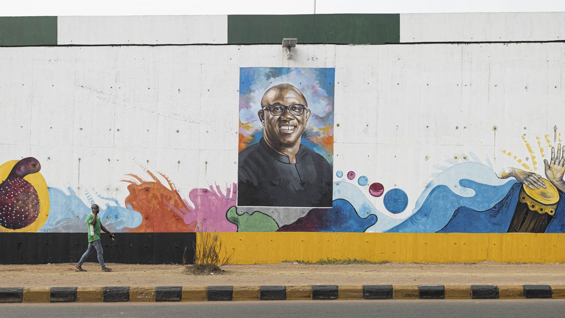 A man walks past a mural depicting Labour Party presidential candidate Peter Obi in Awka, Nigeria, on February 24 (Photo by PATRICK MEINHARDT/AFP via Getty Images)