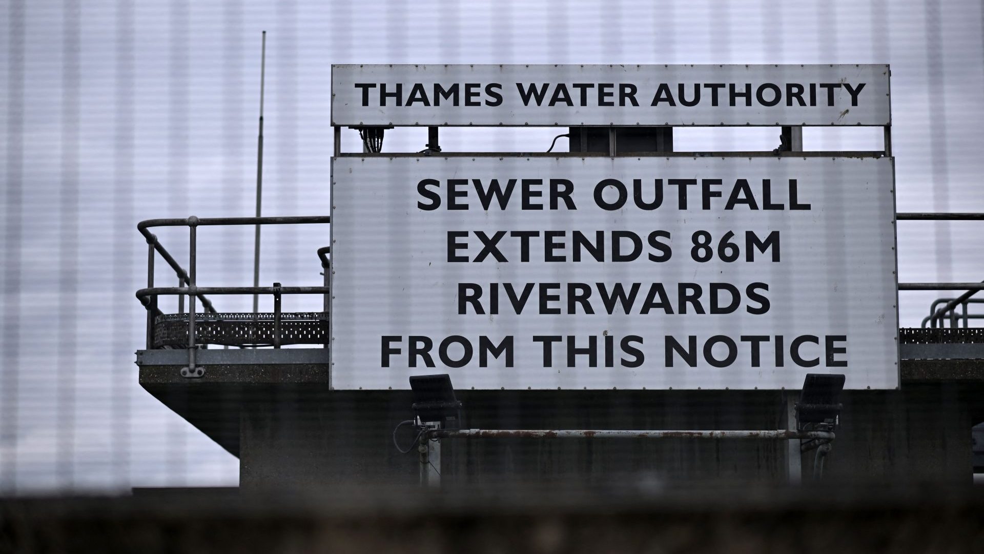 A sign warning of a 'Sewage Outfall' is pictured at the Thames Water Long Reach water treatment facility on the banks of the Thames estuary in Dartford. Photo: BEN STANSALL/AFP via Getty Images