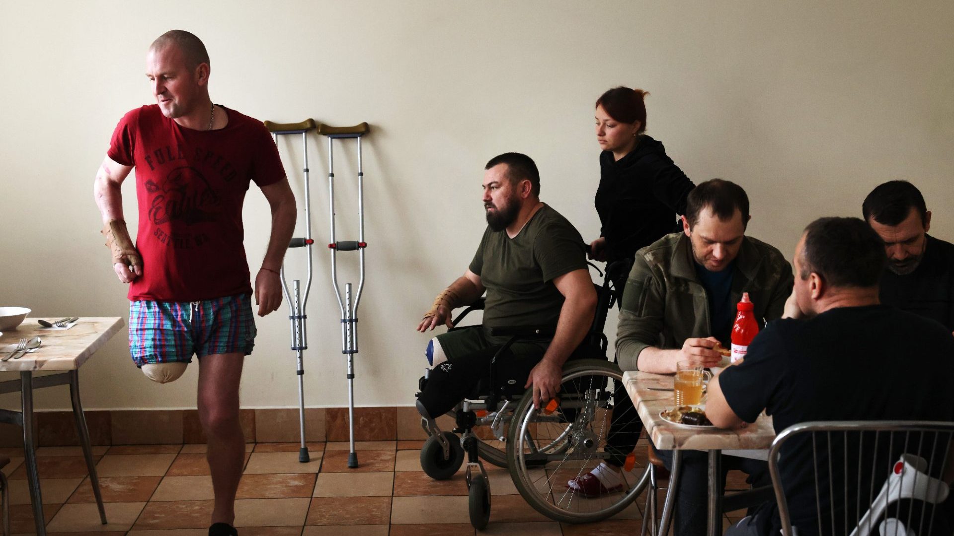 Ukrainian soldiers have lunch at their rehab centre in Lviv. Ivan Nekrasov, centre, lost both legs when his vehicle hit a landmine. Photo: Sean Gallup/AFP/Getty