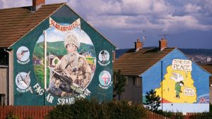 A Republican mural on the Upper Falls Road in Belfast depicts an Irish soldier, while an adjacent mural declares: “Time for Peace”. Photo: Robert Wallis/Corbis/Getty