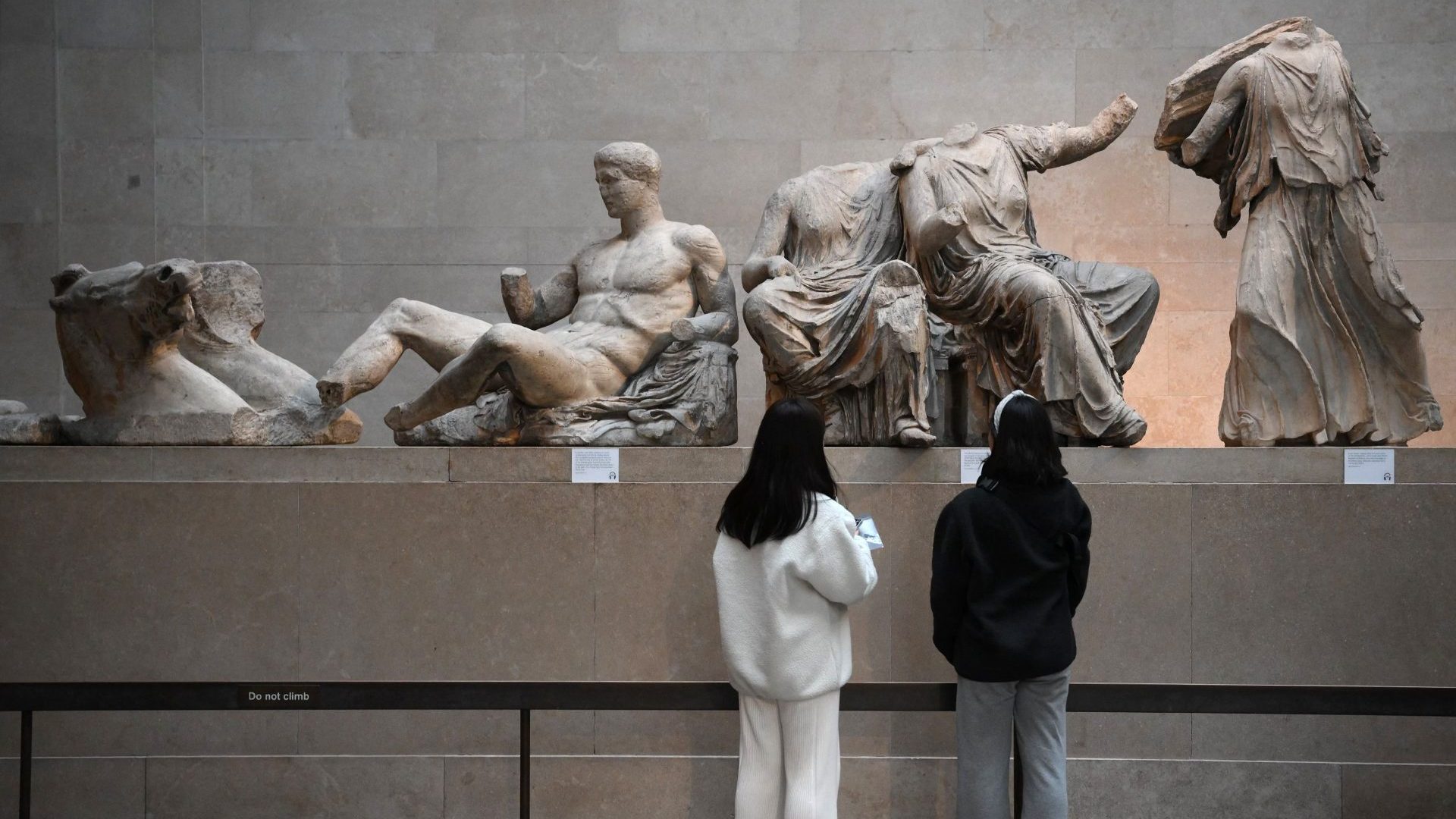 Visitors view the Parthenon Marbles, also known as the Elgin Marbles, at the British Museum in London. Photo:  DANIEL LEAL/AFP via Getty Images