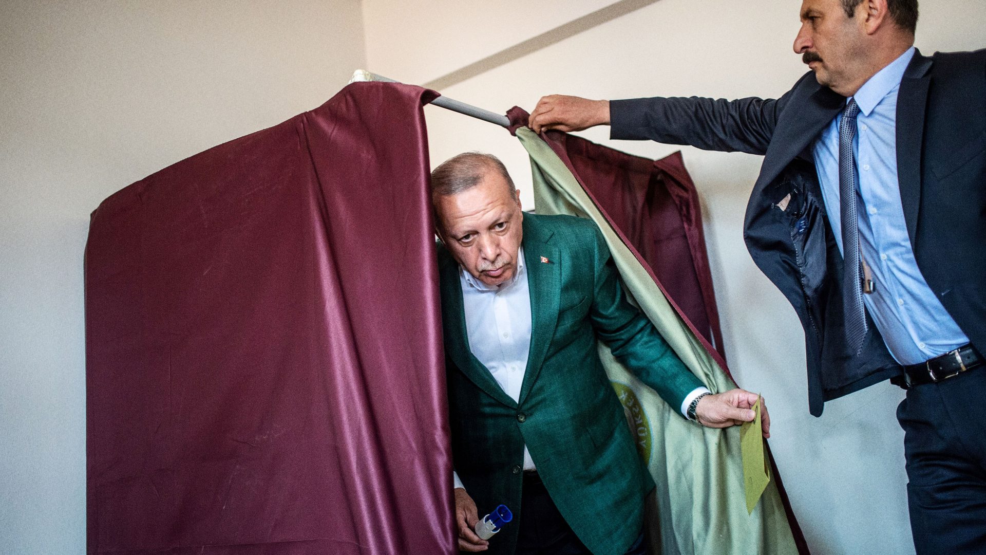 Turkish President Tayyip Erdogan (C) exits a polling booth prior to cast his ballot at a polling station during the municipal elections in 2019. Photo: BULENT KILIC/AFP via Getty Images