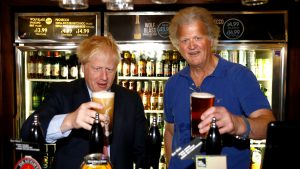 Boris Johnson, then Tory leadership candidate, shares a pint with Tim Martin in London, on the campaign trail in July 2019. Photo: Henry Nicholls/WPA/Getty