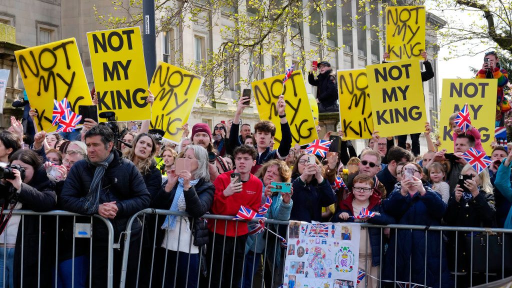 Protesters wait for the arrival of King Charles and Camilla, the Queen Consort, at Liverpool Central Library to officially mark its twinning with Ukraine’s Regional Scientific Library in Odesa, on April 26. Photo: Jon Super/WPA Pool/Getty