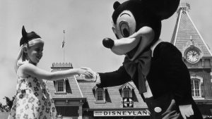 April 1968: A young girl shakes hands with Mickey Mouse at Disneyland, California, during the 40th anniversary of his creation by Walt Disney. Photo: Alan Band/Keystone/Getty