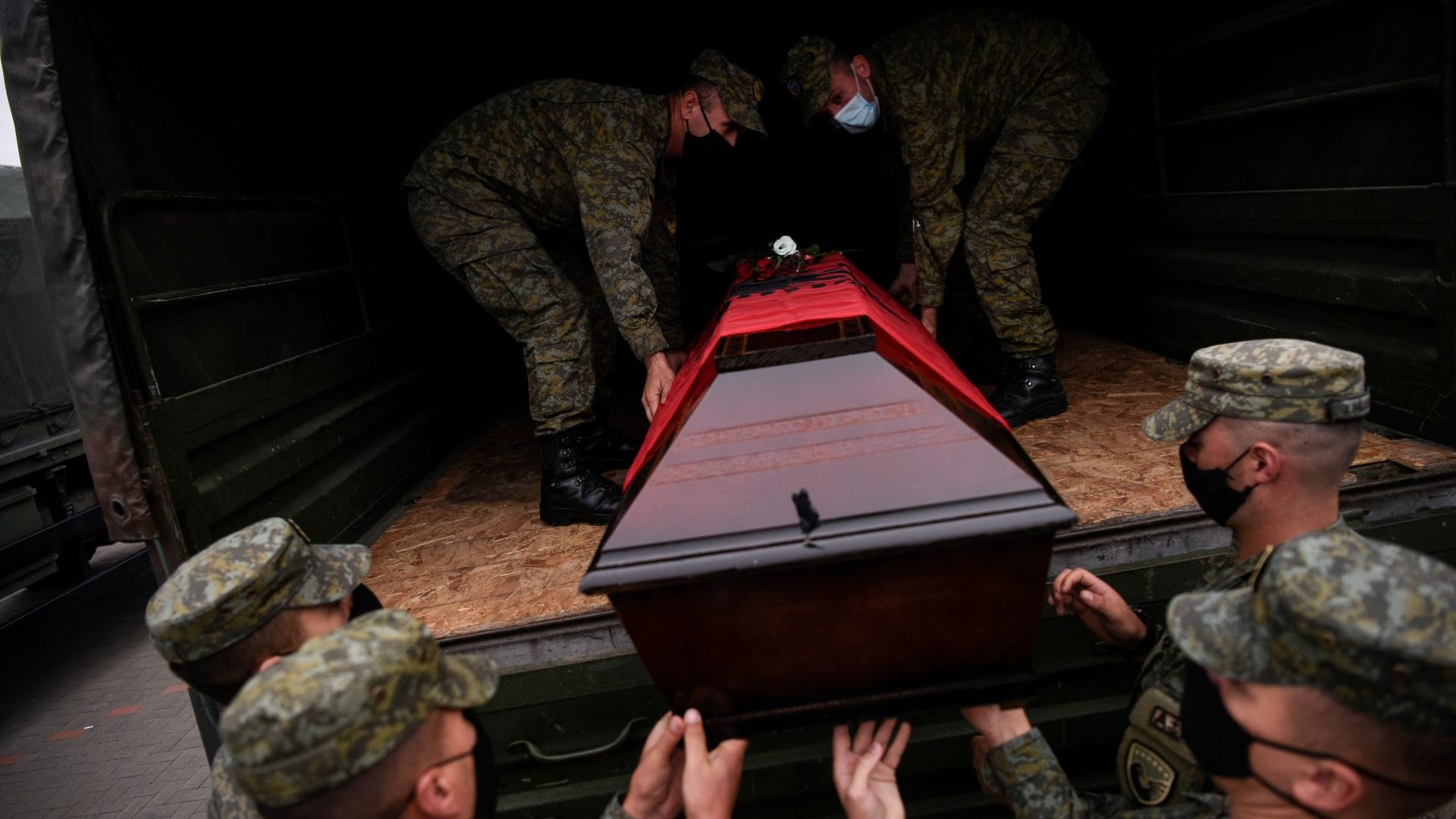 Kosovo soldiers carry coffins bearing the remains of Kosovo Albanians killed by Serbian security forces during the 1998-99 Kosovo War, on September 30, 2021. Photo: ARMEND NIMANI/AFP via Getty Images