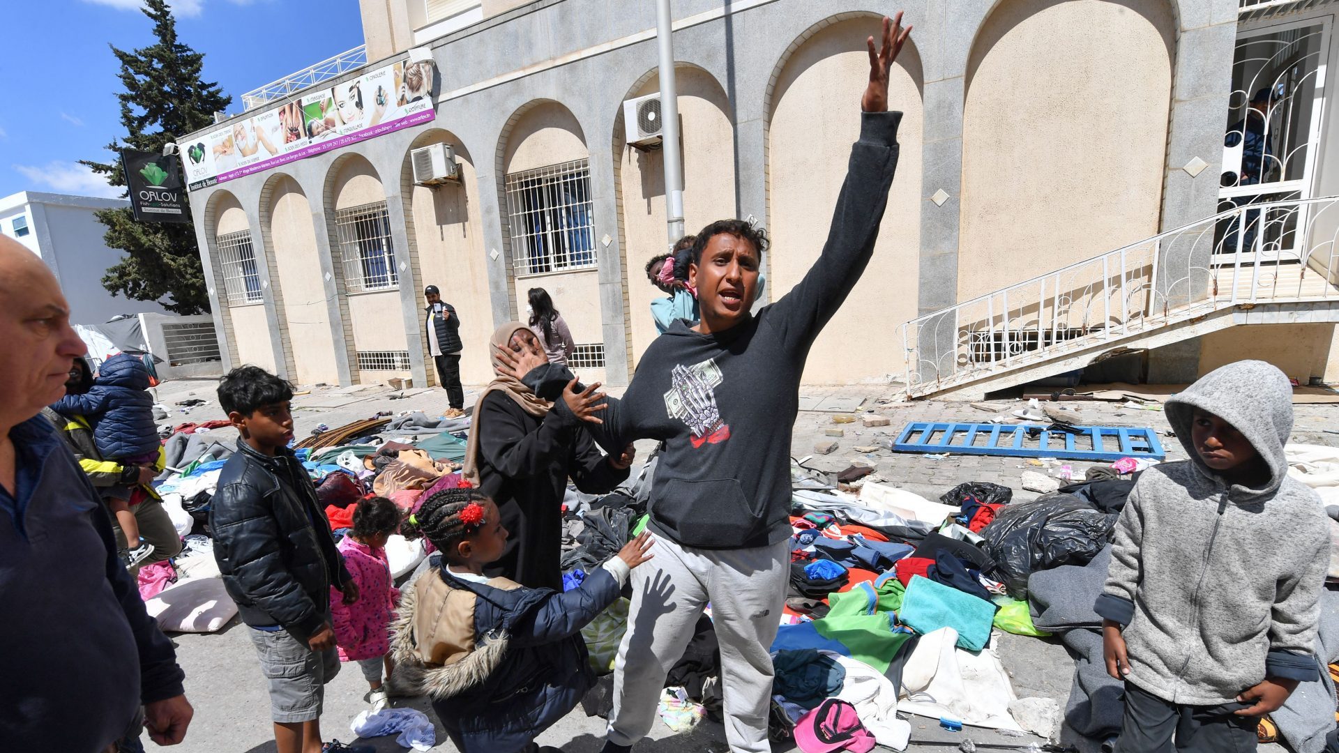 Migrants shout in front of the UNHCR headquarters in Tunis after the police dismantled a camp for refugees from sub-Saharan African countries. Photo: FETHI BELAID / AFP
