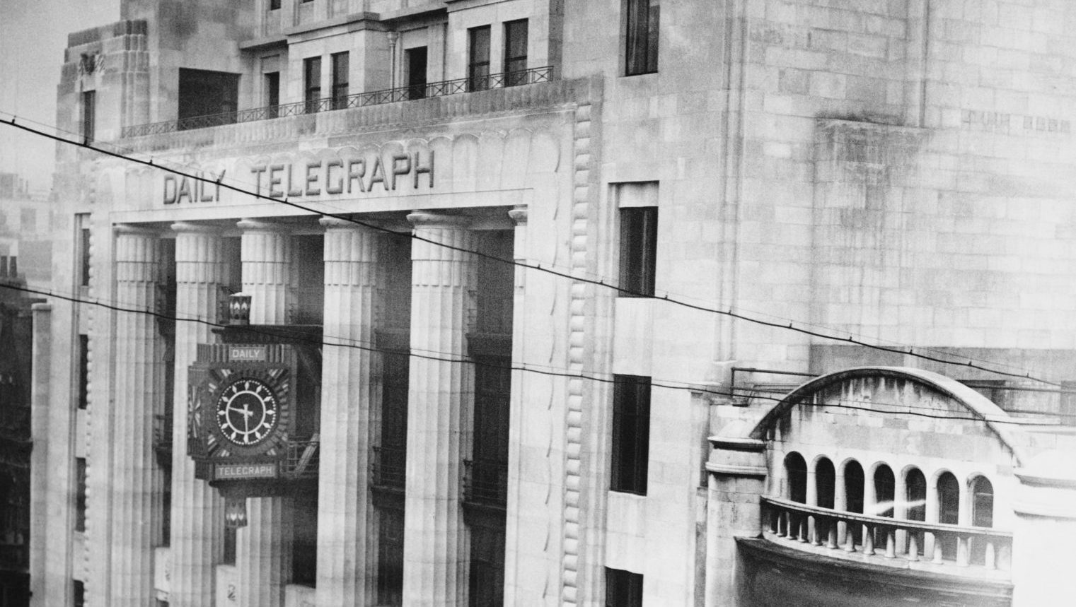 Exterior view of the Daily Telegraph Building, an 8-storey building of Portland stone, showing the clock mounted on the facade, on Fleet Street, in the City of London, England, 1931. Photo: Fox Photos/Hulton Archive/Getty Images