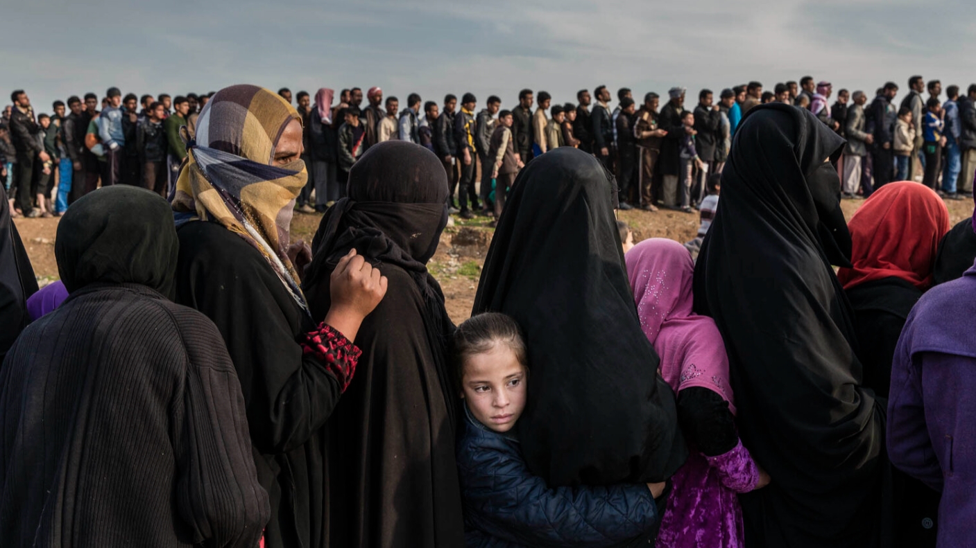 Civilians who had remained in west Mosul during the battle to retake the Iraqi city from Isis line up for aid distribution. All photos on this page: 
Ivor Prickett