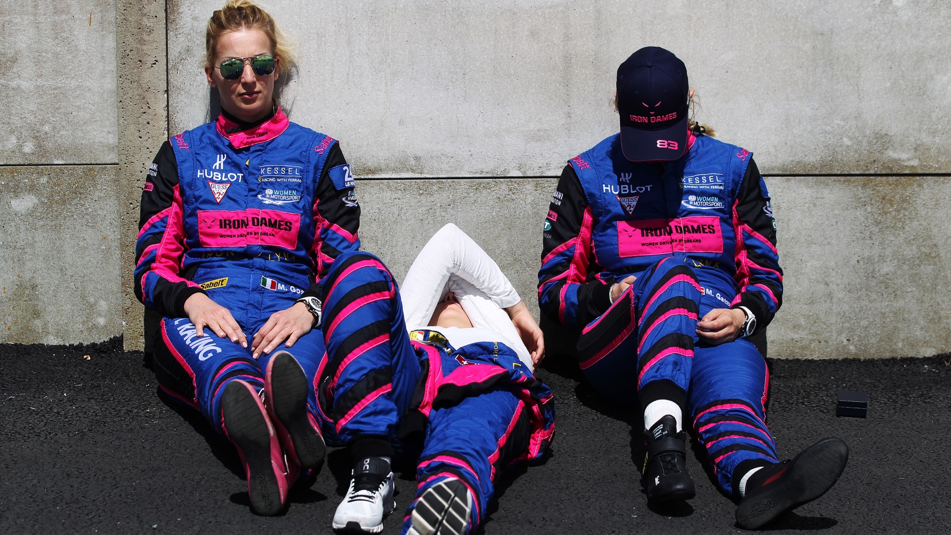 Manuela Gostner, Rahel Frey and Michelle Gatting of the Kessel Racing Ferrari 488 GTE team relax before the 2019 Le Mans race. Photo: Ker Robertson/Getty