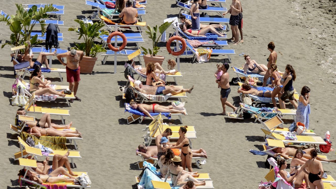 Bathers are on chaise longues on a beach in Posillipo District, after Italian government has stopped a nationwide lockdown that was due to the spread of the coronavirus disease. Photo: Salvatore Laporta/KONTROLAB/LightRocket via Getty Images