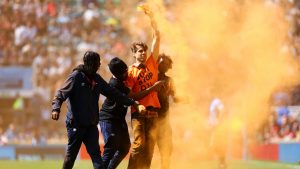 A 'Just Stop Oil' protestor invades the pitch and is apprehended by stewards during the Gallagher Premiership Final between Saracens and Sale Sharks. Photo: Clive Rose/Getty Images