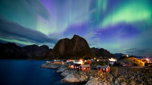 The aurora borealis illuminates the sky over Reinfjorden in Reine, Lofoten Islands. Photo: Jonathan Nackstrand/AFP/ Getty