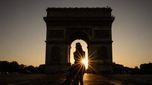 A sunset photo opportunity at the Arc de Triomphe in a quieter-than-usual Paris. Photo: Matthias Hangst/Getty