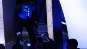 With the debate stage in Milwaukee bathed in blue light, Republican presidential candidate Vivek Ramaswamy greets admirers in the audience. Photo: Win McNamee/Getty