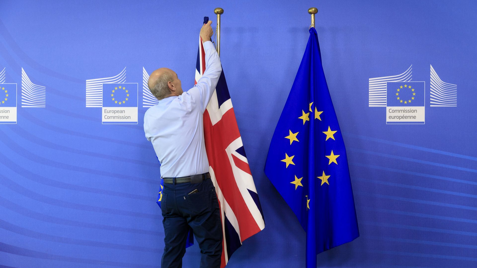 A man takes down the British flag at the European Commission. Photo: Andia/Universal Images/Getty