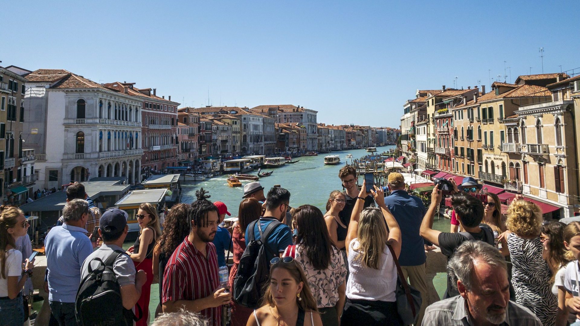 Tourists throng the Rialto Bridge overlooking the Grand Canal. Photo: Jumping Rocks/Education Images/Universal Images Group