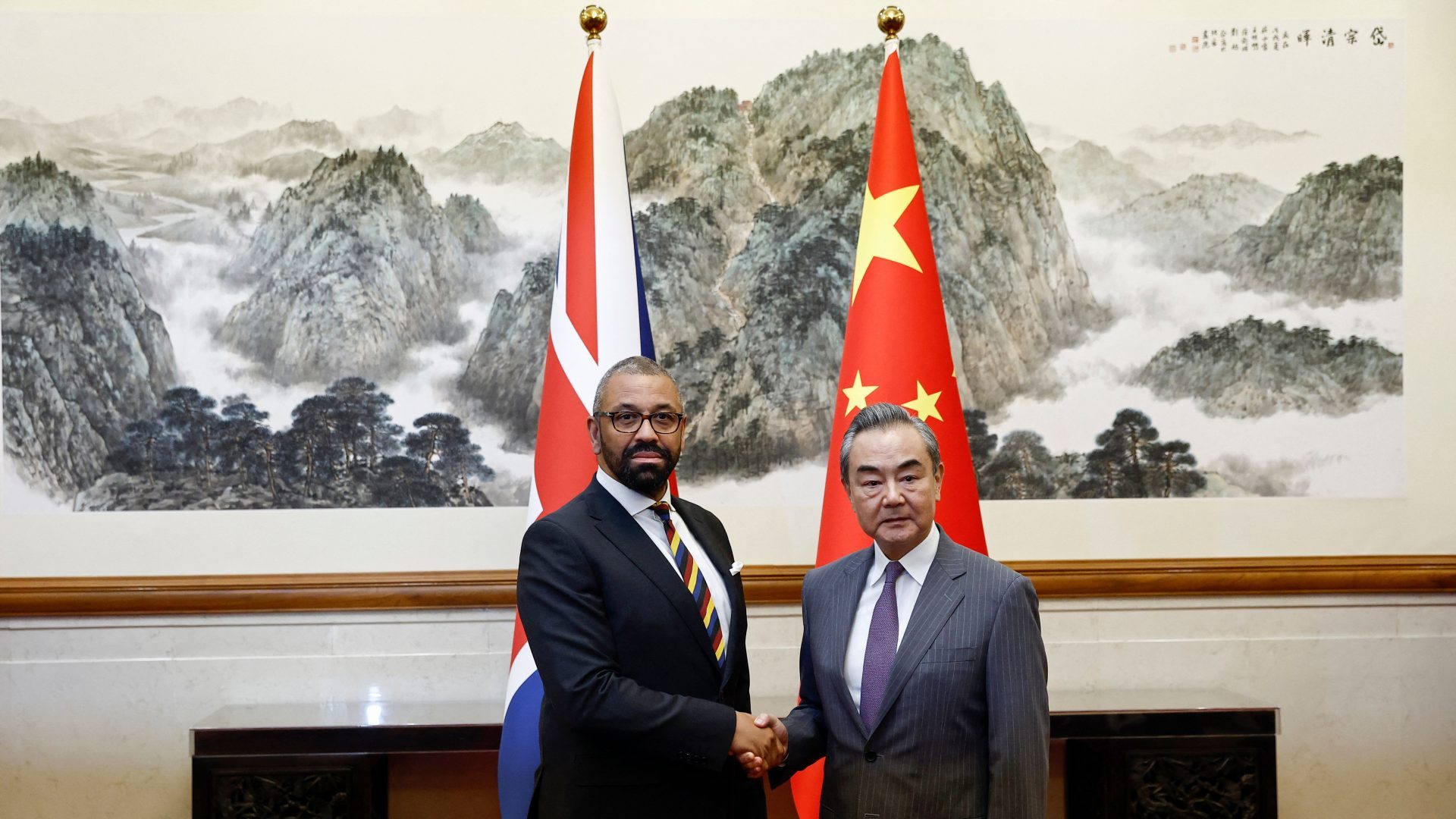 British Foreign Secretary James Cleverly (L) and Chinese Foreign Minister Wang Yi shake hands before a meeting at the Diaoyutai State Guesthouse in Beijing. Photo: FLORENCE LO/POOL/AFP via Getty Images