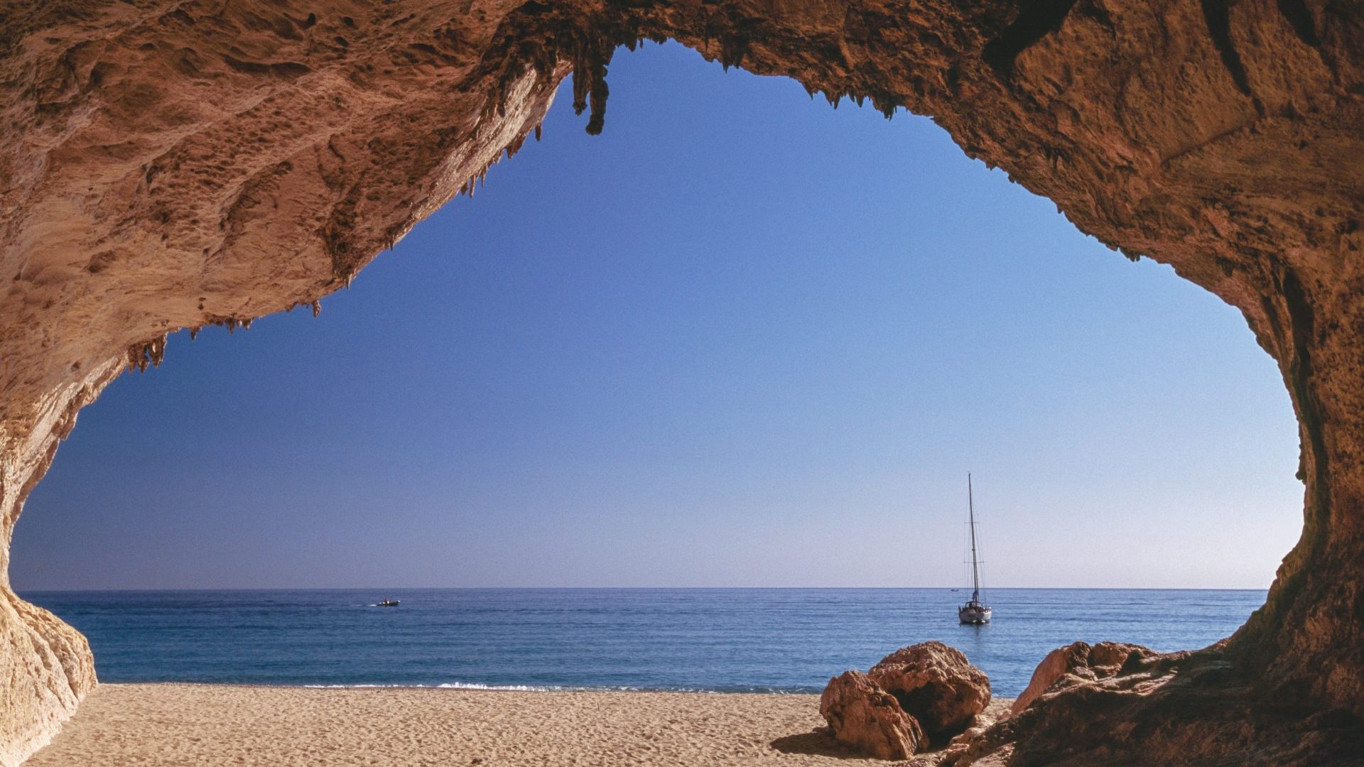 The view from a cave on the beach of Cala Luna on the eastern coast of Sardinia. Photo: Dea/V Giannella/Getty