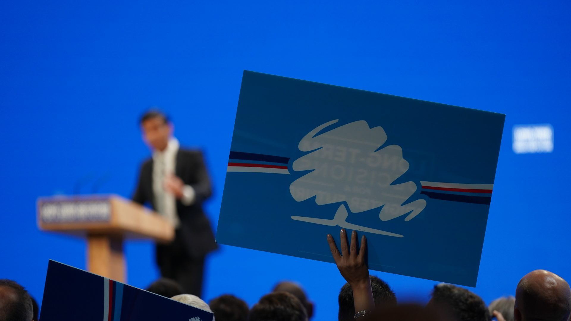 People hold up signs in support of the Conservative party during prime minister Rishi Sunak's speech. Photo: Ian Forsyth/Getty Images