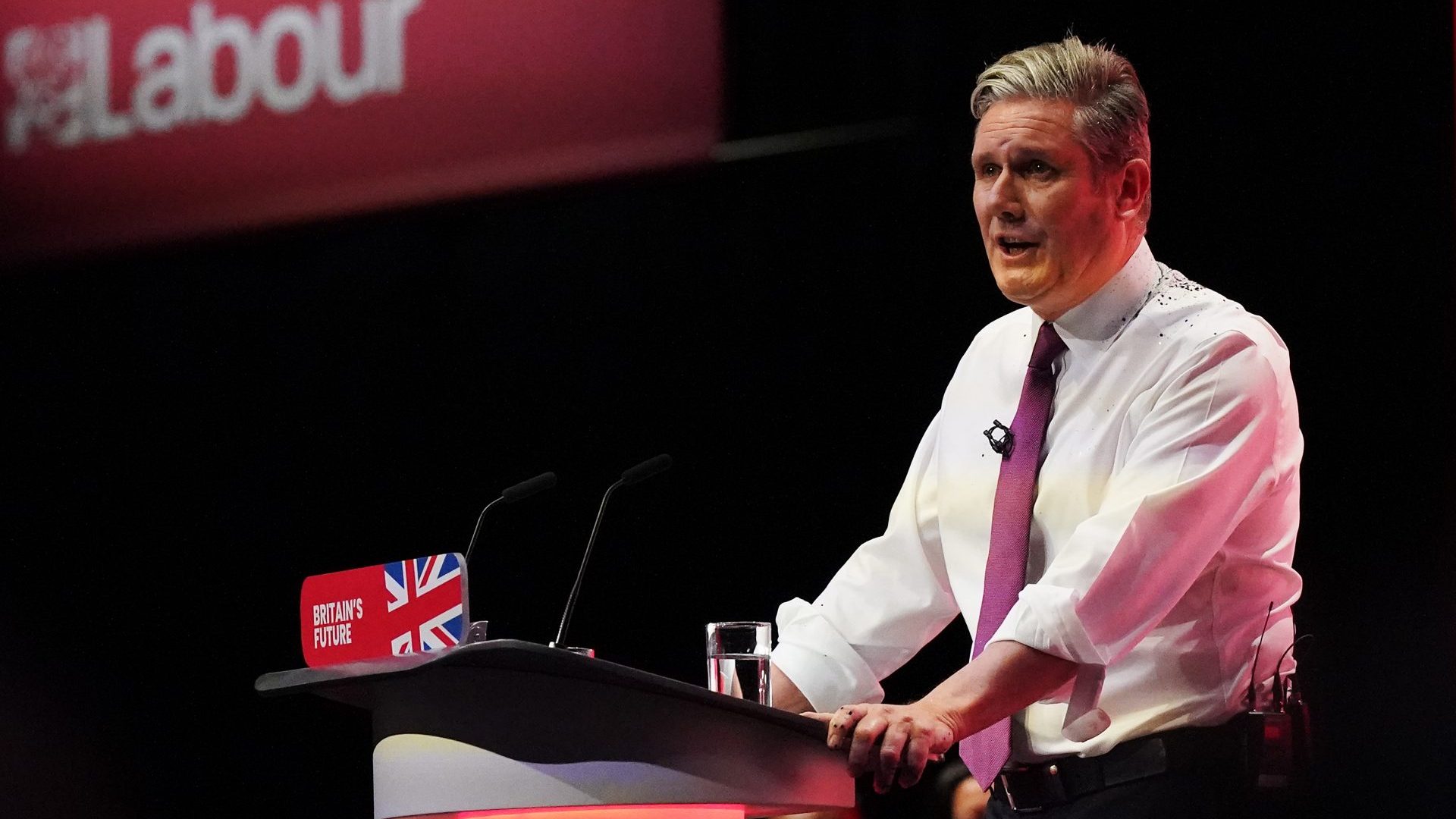 Keir Starmer delivers the leader's speech, covered in glitter after a protestor stormed the stage on the third day of the Labour Party conference (Photo by Ian Forsyth/Getty Images)