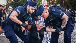 Prominent anti-government activist Katarzyna Augustynek, known as Babcia Kasia (Grandma Kate), is carried away by police during a protest in Kraków last month Photo: Beata Zawrzel/NurPhoto/Getty