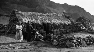 A family beside their home, Tristan De Cunha (Photo © Hulton-Deutsch Collection/CORBIS/Corbis via Getty Images)