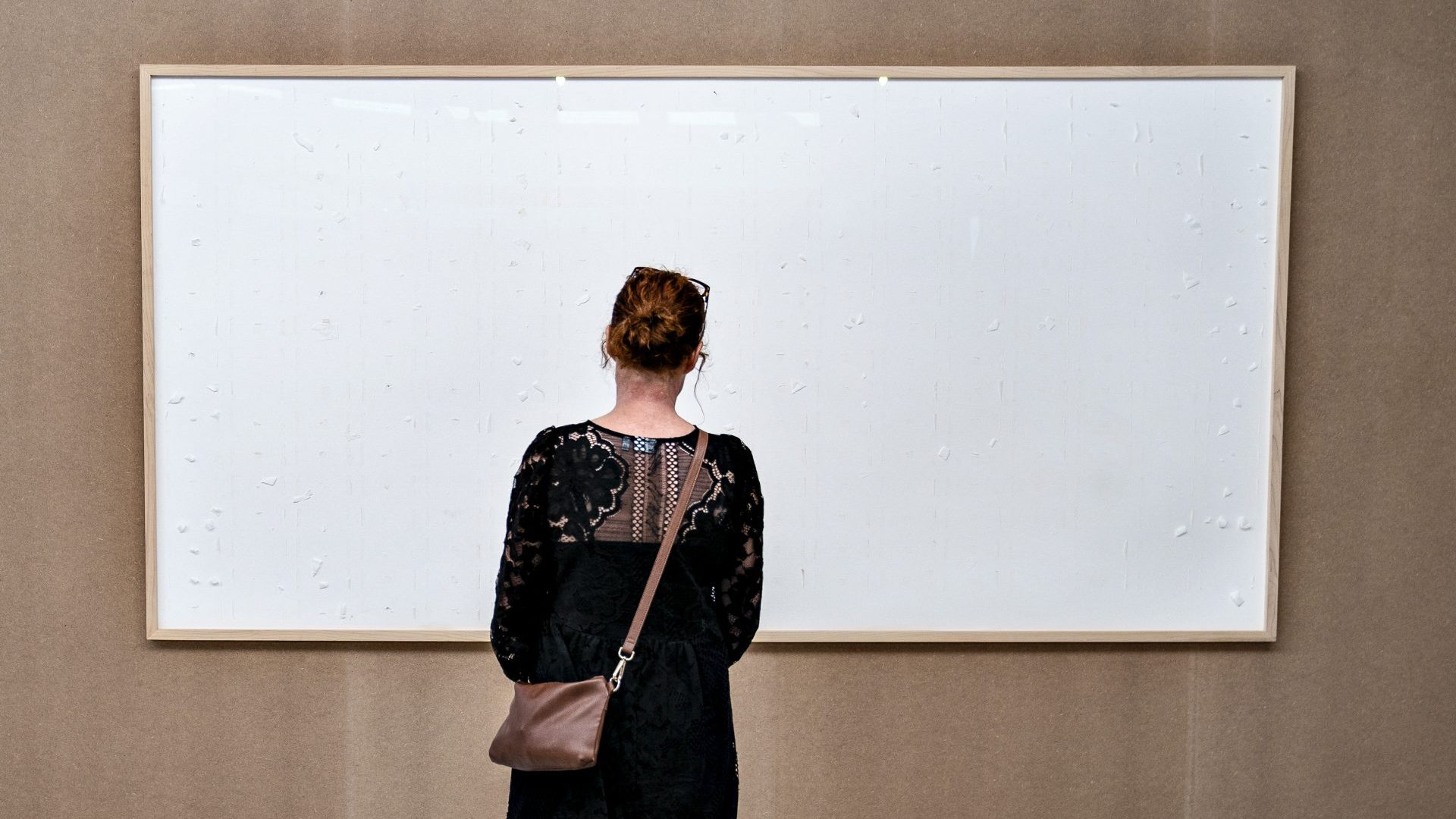 A woman stands in front of Jens  Haaning’s controversial Take the Money and Run at the Kunsten Museum in Aalborg. Photo: Henning Bagger/Ritzau Scanpix/AFP/Getty