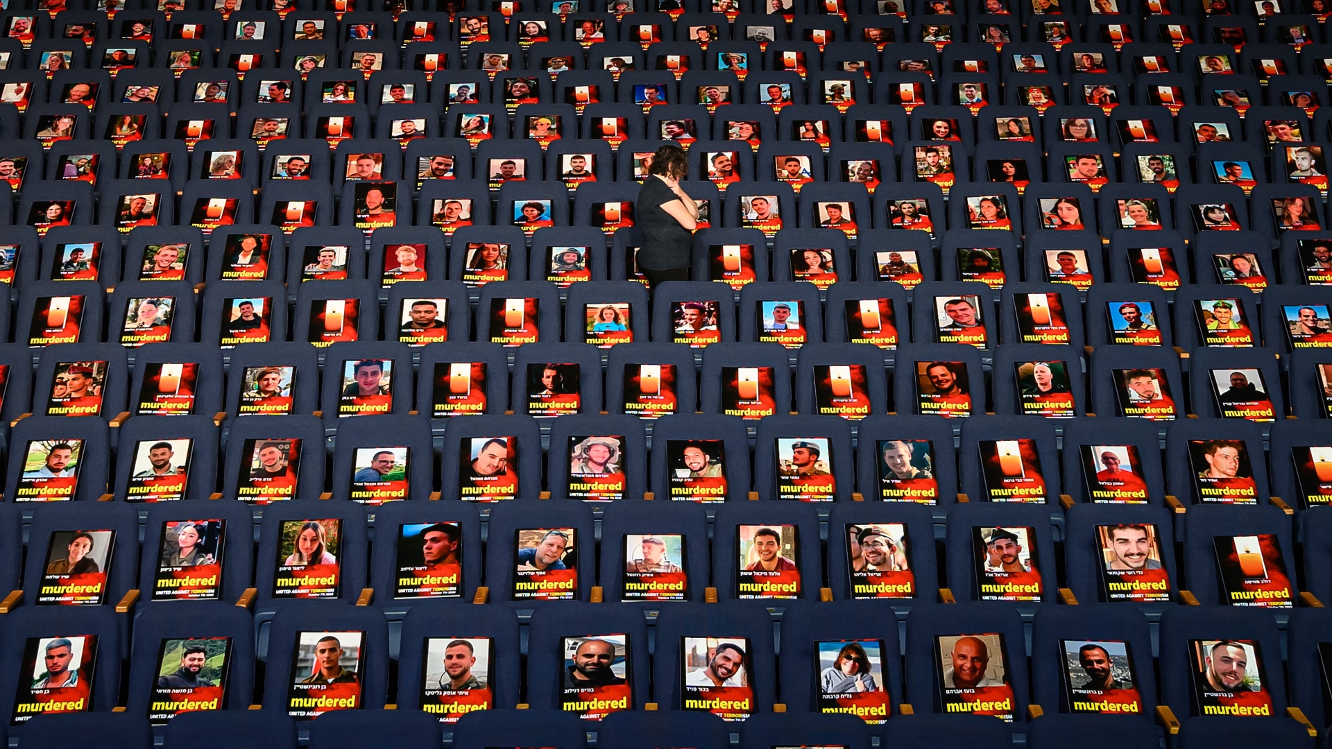 Pictures of more than 1,000 people abducted, missing or killed by Hamas in the October 7 attacks are displayed

on empty seats in the Smolarz Auditorium at Tel Aviv University. Photo: Leon Neal/Getty