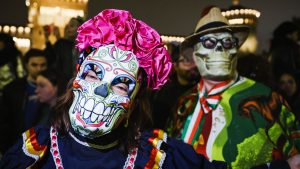 People wear traditional costumes at the Mexican parade for the Dia De Muertos celebrations in Milan. Photo: Alessandro Bremec/NurPhoto via Getty Images