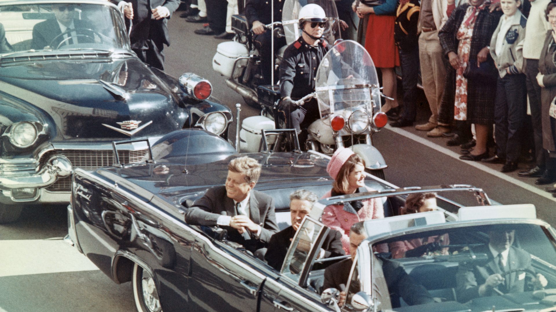 John F Kennedy, Jacqueline Kennedy and Texas governor John Connally smile at the crowds in Dallas on November 22, 1963. Minutes later the president was assassinated
