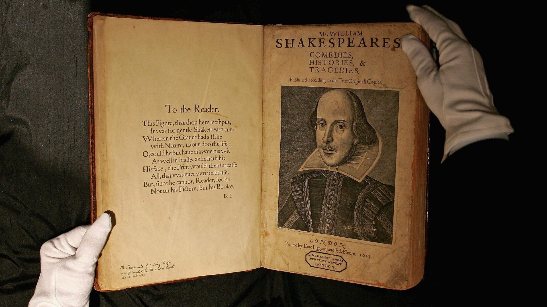 A Sotheby’s employee handles a copy of the most important book in English literature, William Shakespeare’s First Folio from 1623, prior to its sale at auction in 2006. Photo: Scott Barbour/Getty